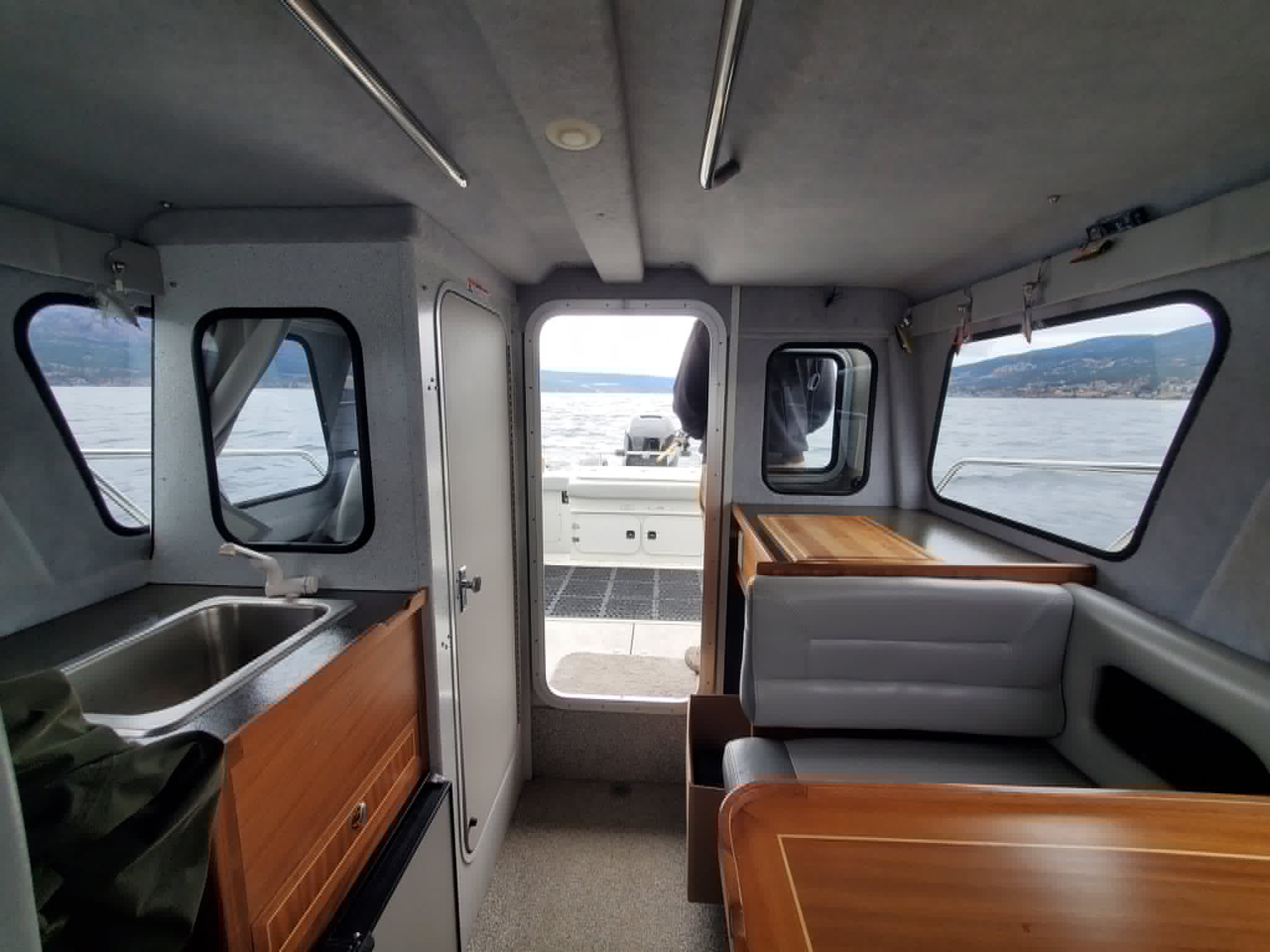 Kingfisher 2525 heated cabin interior with wood trim and dinette