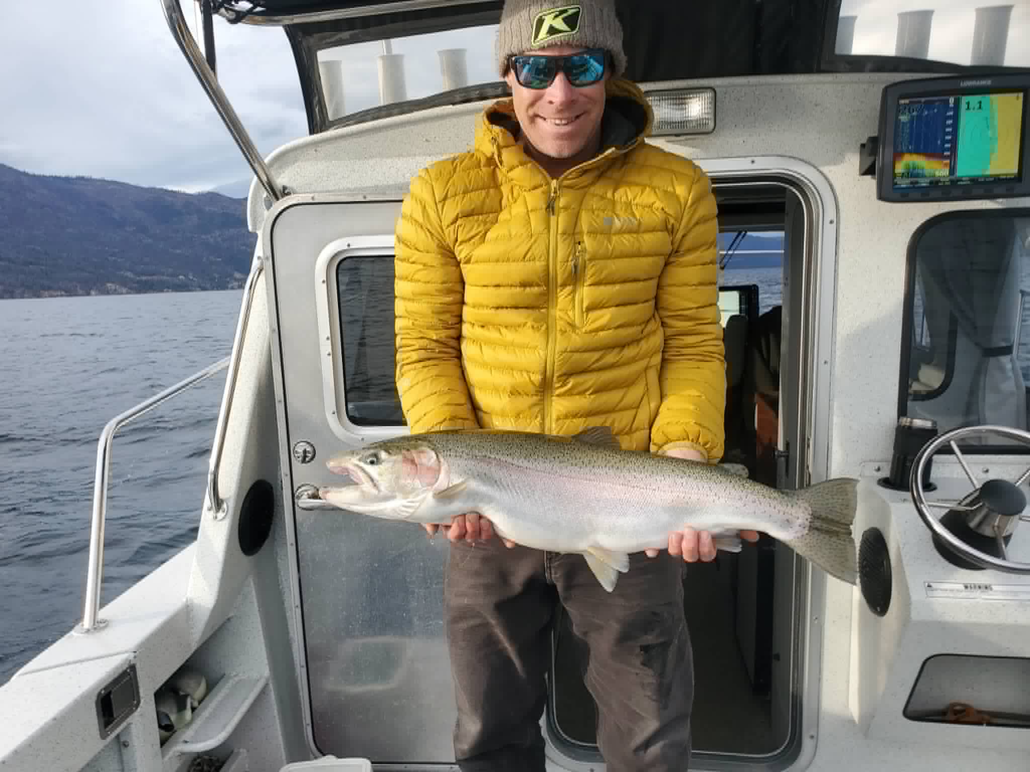 Captain Dennis Barnes with a trophy rainbow trout on Okanagan Lake