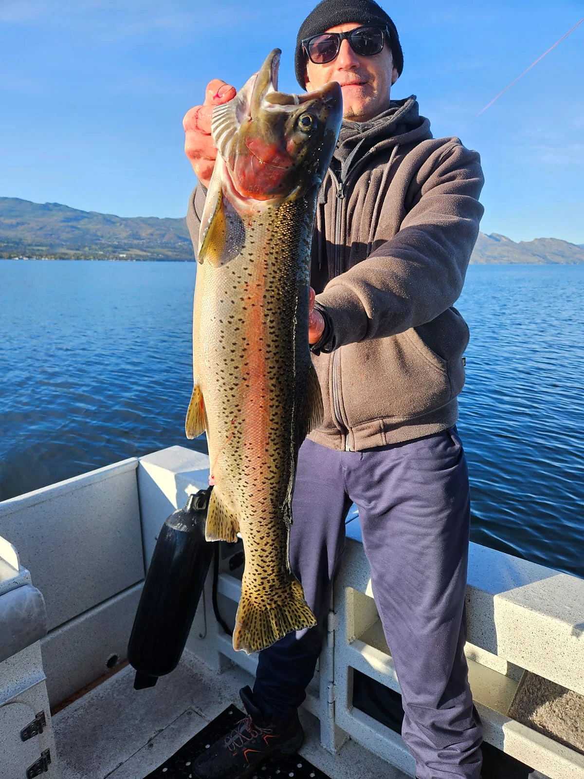 Guest holding a trophy rainbow trout on Okanagan Lake