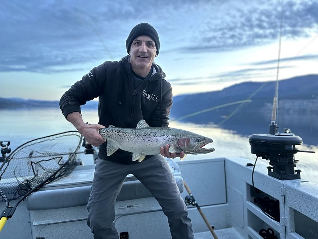 Golden-hour trophy rainbow trout aboard the Kingfisher