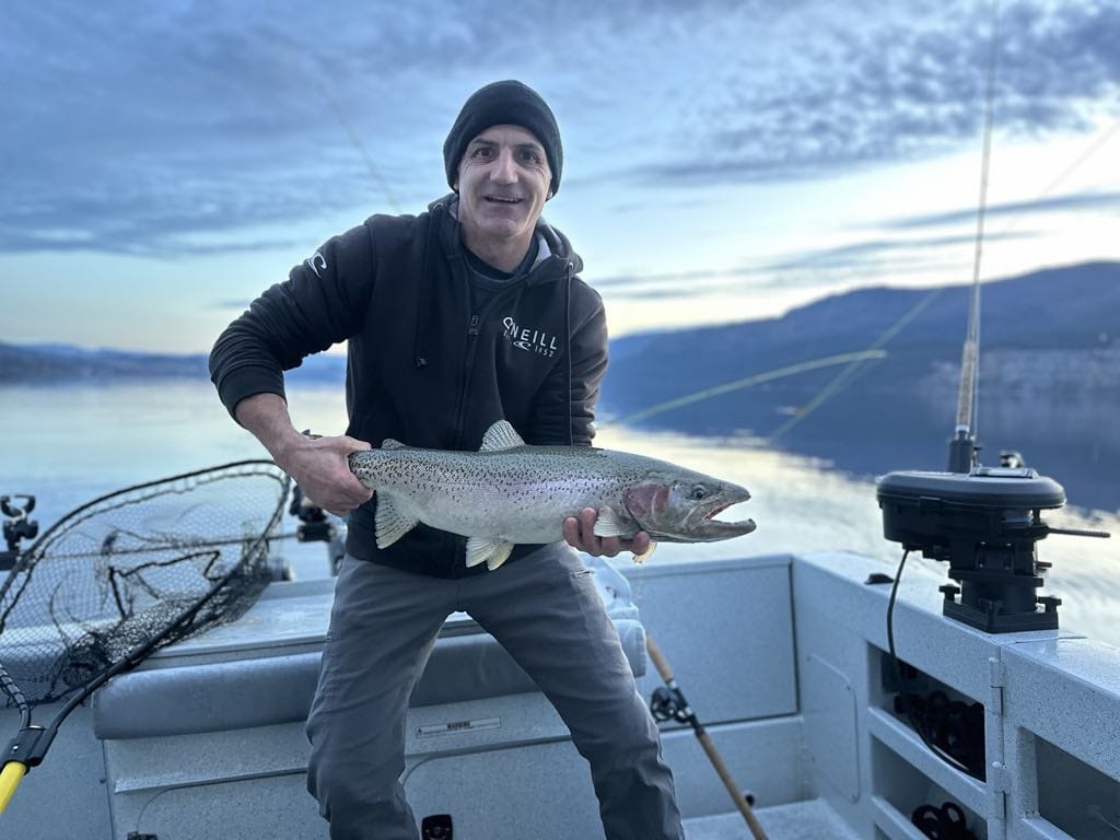 Golden-hour trophy rainbow trout aboard the Kingfisher