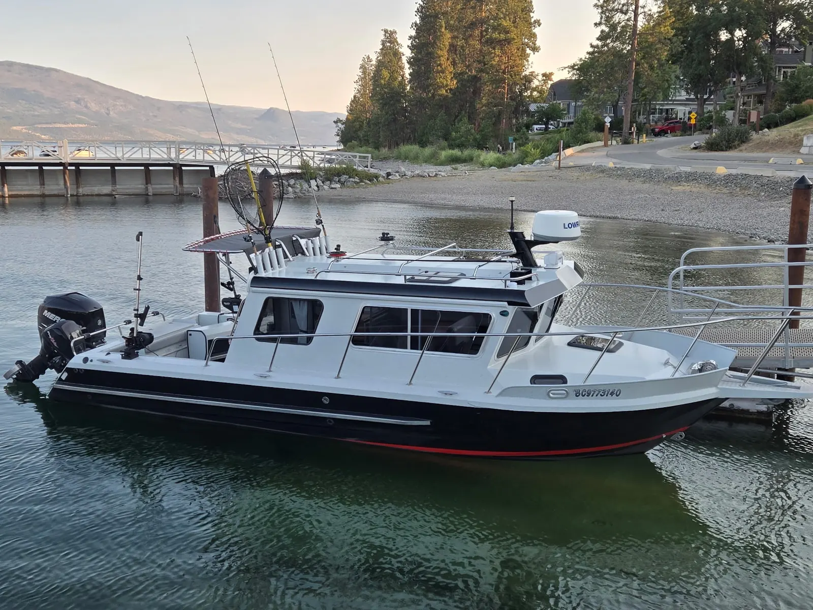 Kingfisher 2525 Weekender at the Okanagan boat launch at golden hour, rods rigged and ready