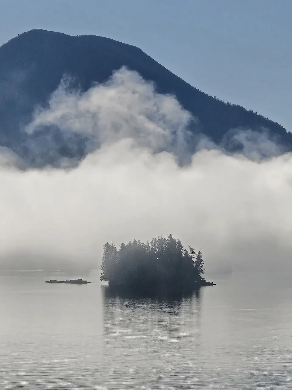 Morning fog lifting off an island on the coast